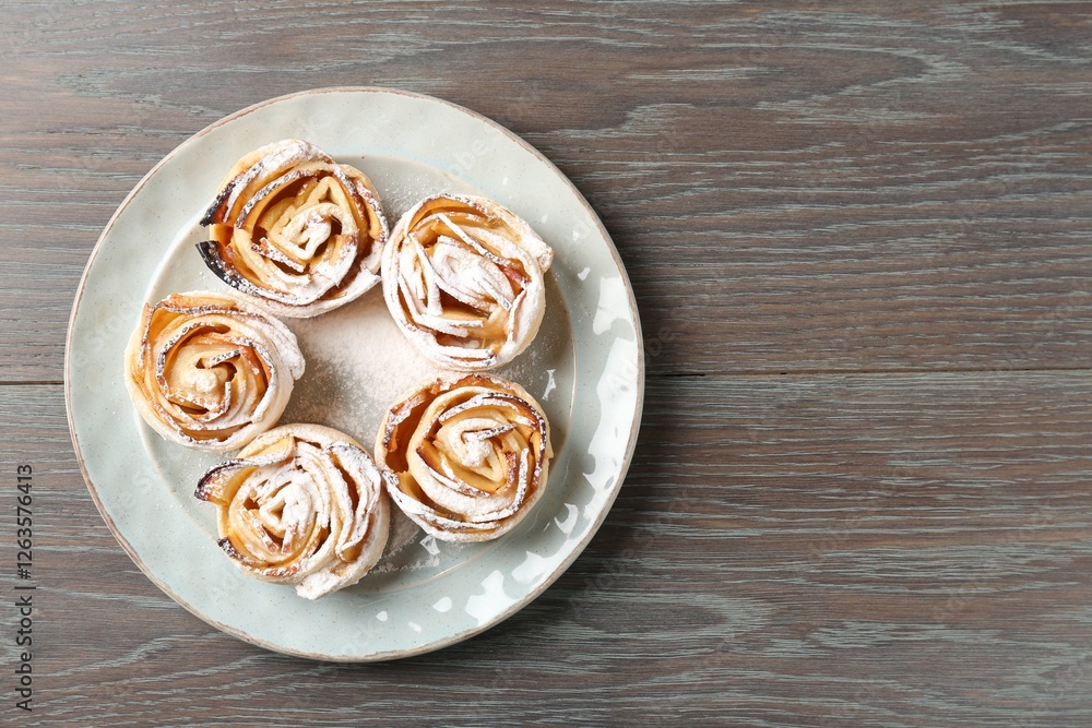 Freshly baked apple roses on wooden table, top view. Space for text Freshly baked apple roses on wooden table, top view. Space for text