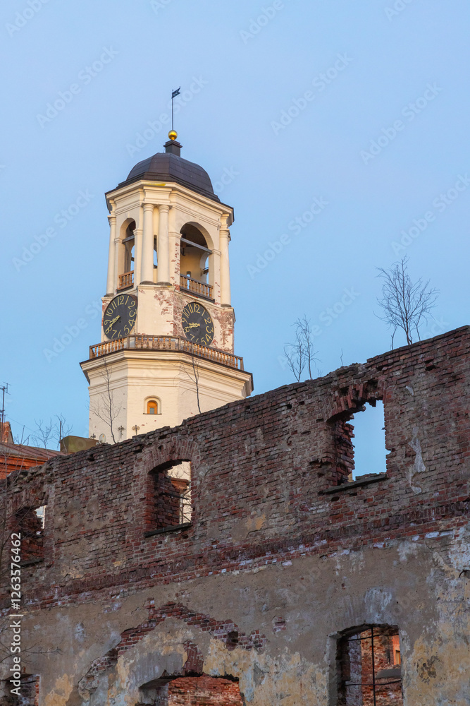 Fototapeta premium Old Clock Tower and broken brick walls of destroyed cathedral