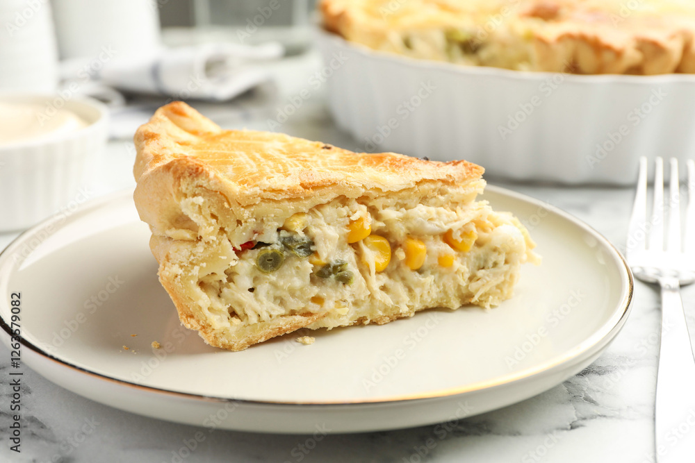 Piece of tasty homemade pie with chicken and vegetables on white marble table, closeup Piece of tasty homemade pie with chicken and vegetables on white marble table, closeup