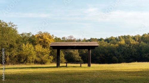 Empty wooden gazebo in a meadow, sunny autumn day, scenic background photo