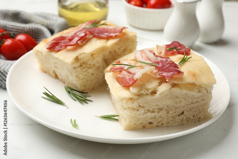 Pieces of delicious focaccia bread with bacon served on white table, closeup Pieces of delicious focaccia bread with bacon served on white table, closeup