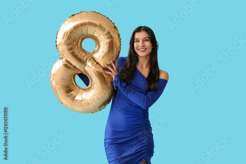 Happy young woman with gold...