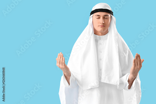 Young Muslim man praying on...