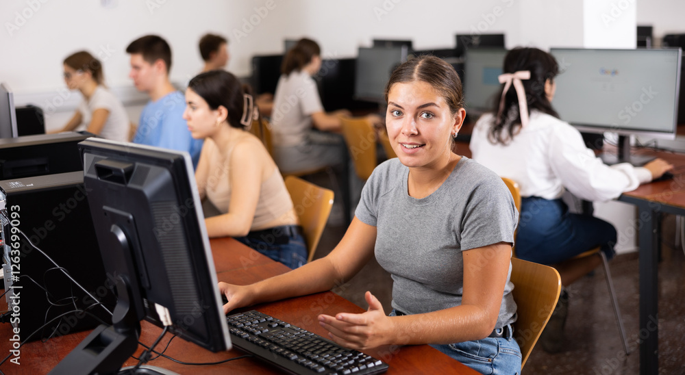 Fototapeta premium Teacher works at the computer in the classroom. Students doing programming