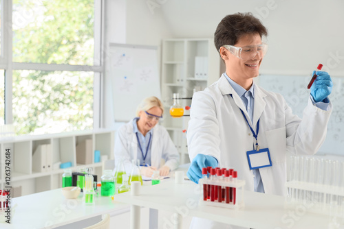 Male chemist with test tube...