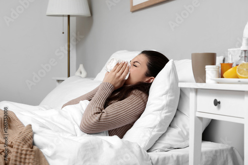 Ill young woman with tissue...