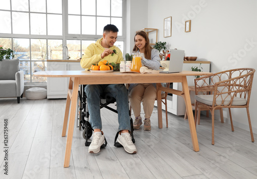 Young man in wheelchair and...