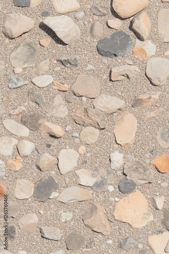 Textured surface of mixed stones and sand, ideal for backgrounds