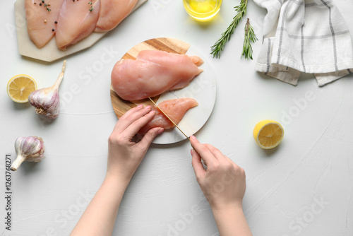 Raw chicken breast slicing ...