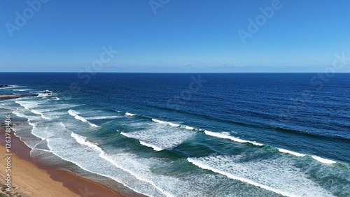 Drone shot aerial view of a beach and waves in Australia in summer 