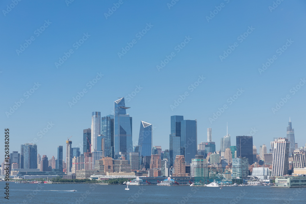 Stunning skyline view of a bustling city with clear blue sky and modern architecture along the waterfront Stunning skyline view of a bustling city with clear blue sky and modern architecture along the waterfront