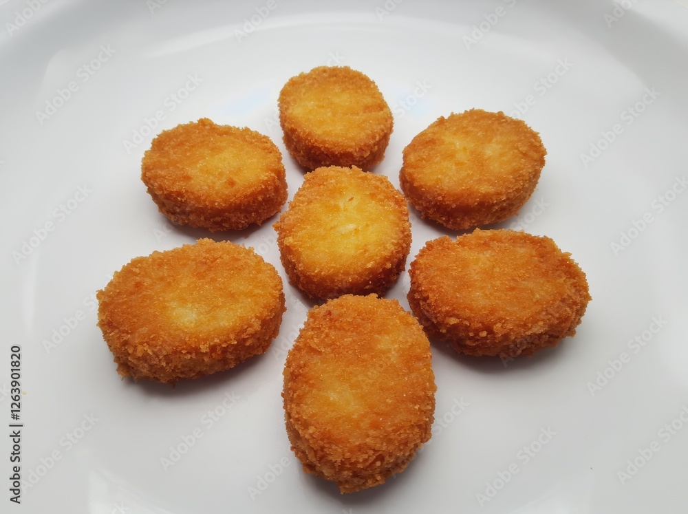 Seven Fried Chicken Nuggets on White Plate Seven Fried Chicken Nuggets on White Plate