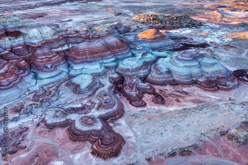 Aerial view of the Bentonite Hills during the blue hour after sunset showing the multi-colored layers of clay and sediment near the Mars Desert Research Station near Hanksville, Utah. photo