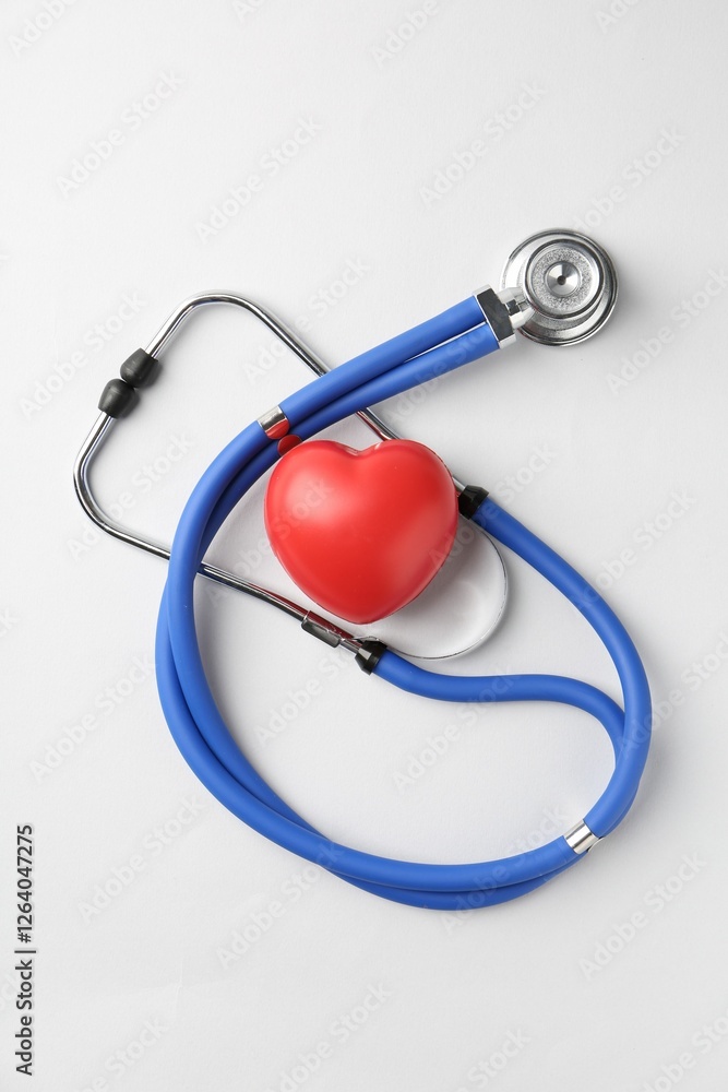 Cardiology. Stethoscope and red decorative heart on white background, flat lay