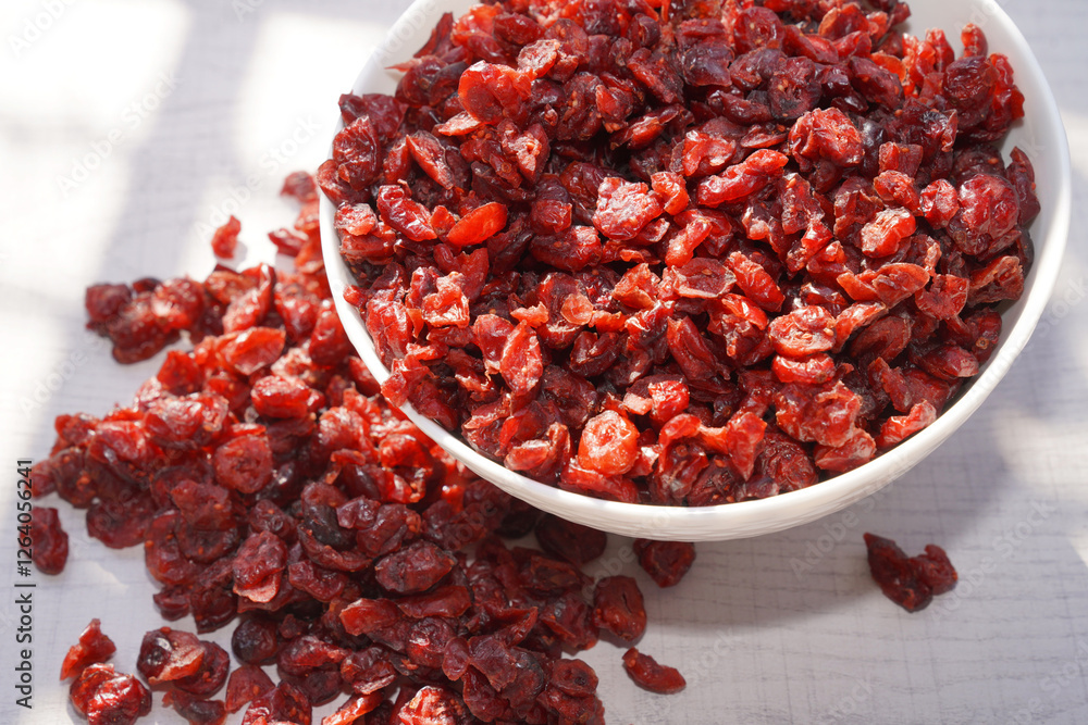 Dried cranberries in white bowl on table. Dried cranberries in white bowl on table.
