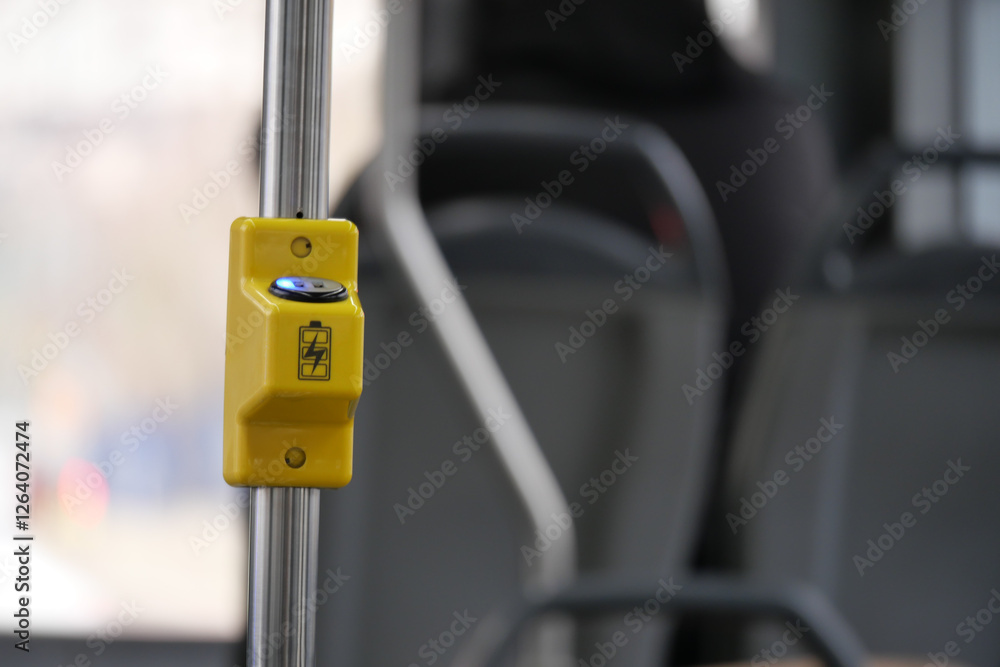 Yellow stop button on public transport in urban setting Yellow stop button on public transport in urban setting