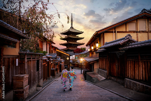 Asian women wearing traditional japanese kimono among at Yasaka Pagoda and Sannen Zaka Street in Kyoto, Japan. photo