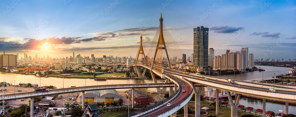 Fototapeta premium The Bhumibol Bridge (Industrial Ring Road Bridge) (Bangkok, Thailand) Beautiful view at sunset, Bangkok Expressway top view, expressway and motorway at sunset Aerial view from drone