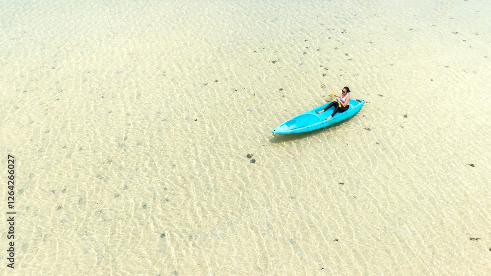 Aerial view of a kayak in the blue sea .man kayaking he does water sports activities.	