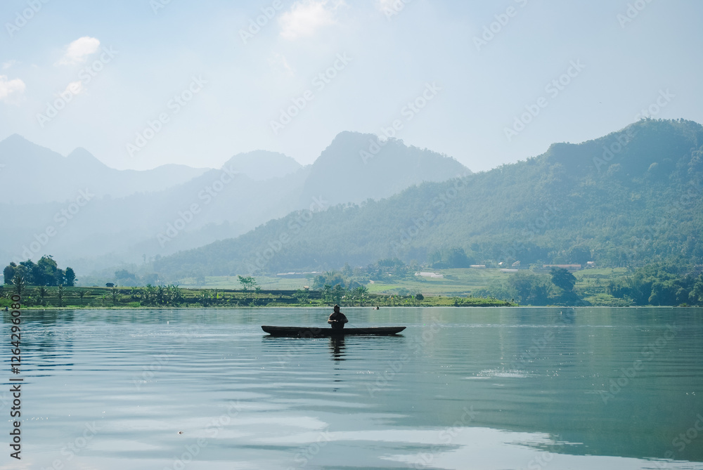 Fishermen in small boats are looking for fish in an Indonesian lake Fishermen in small boats are looking for fish in an Indonesian lake