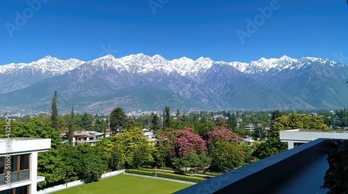 Scenic view of snow-capped mountains with lush greenery and blooming flowers in foreground