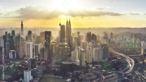 4k time lapse of dancing clouds and sun rays over KL skyline. 