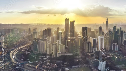 4k time lapse of dancing clouds and sun rays over KL skyline. 