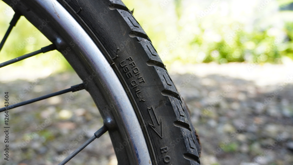 Obraz premium Close-up of a Motorcycle Tire with Brand and Model Engraving