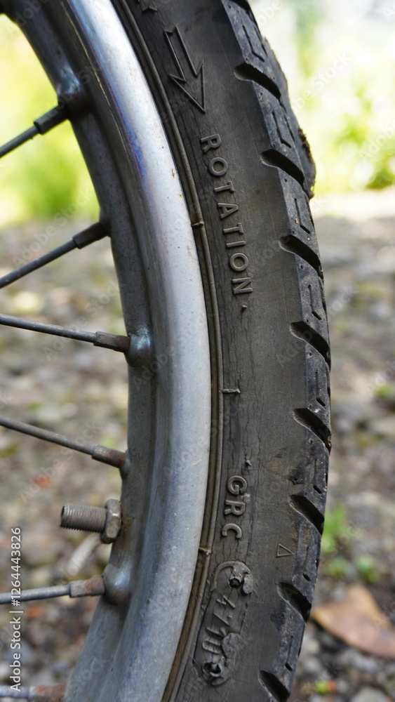 Close-up of a Motorcycle Tire with Brand and Model Engraving Close-up of a Motorcycle Tire with Brand and Model Engraving