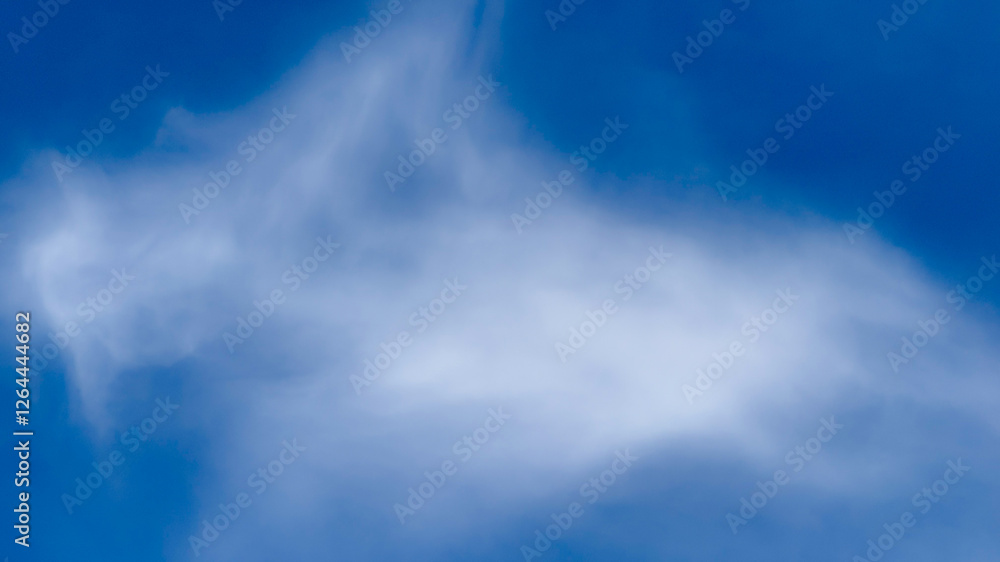 Obraz premium Fluffy white cloud resembling a horse against a vibrant blue sky, dream interpretation, nature wonder, imaginative cloud shapes, peaceful serene backdrop