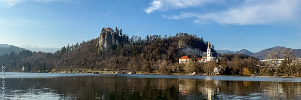 Fototapeta premium Majestic castle atop a forested hill near Lake Bled, Slovenia, serene travel destination, European architecture
