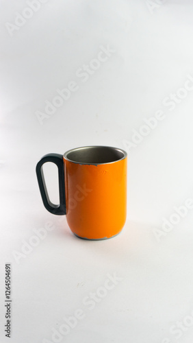 an orange cup whose paint has started to peel off, isolated on white
