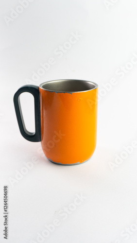 an orange cup whose paint has started to peel off, isolated on white