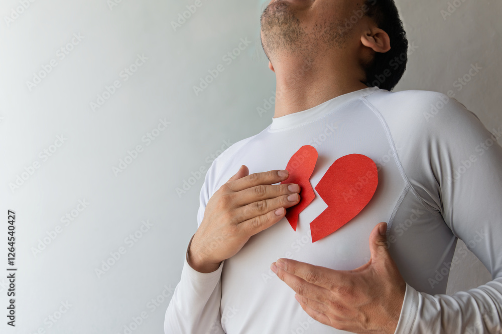 Man expresses heartbreak with paper cutout in emotional portrayal of love lost Man expresses heartbreak with paper cutout in emotional portrayal of love lost