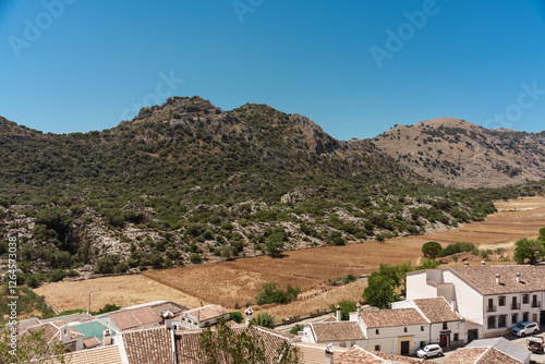 General plan of the fields, mountains, clear sky and houses of an Andalusian village in southern Spain.