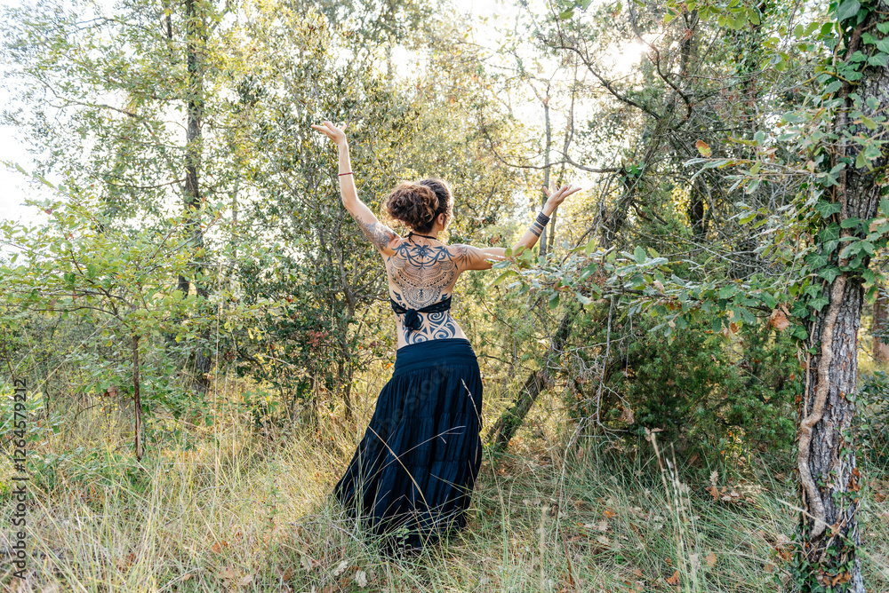 Female Tribal Dancer Performs in Woods With Intricate Tattoos on Back Female Tribal Dancer Performs in Woods With Intricate Tattoos on Back