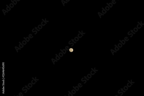 Full moon from afar against a black background of the night sky photo