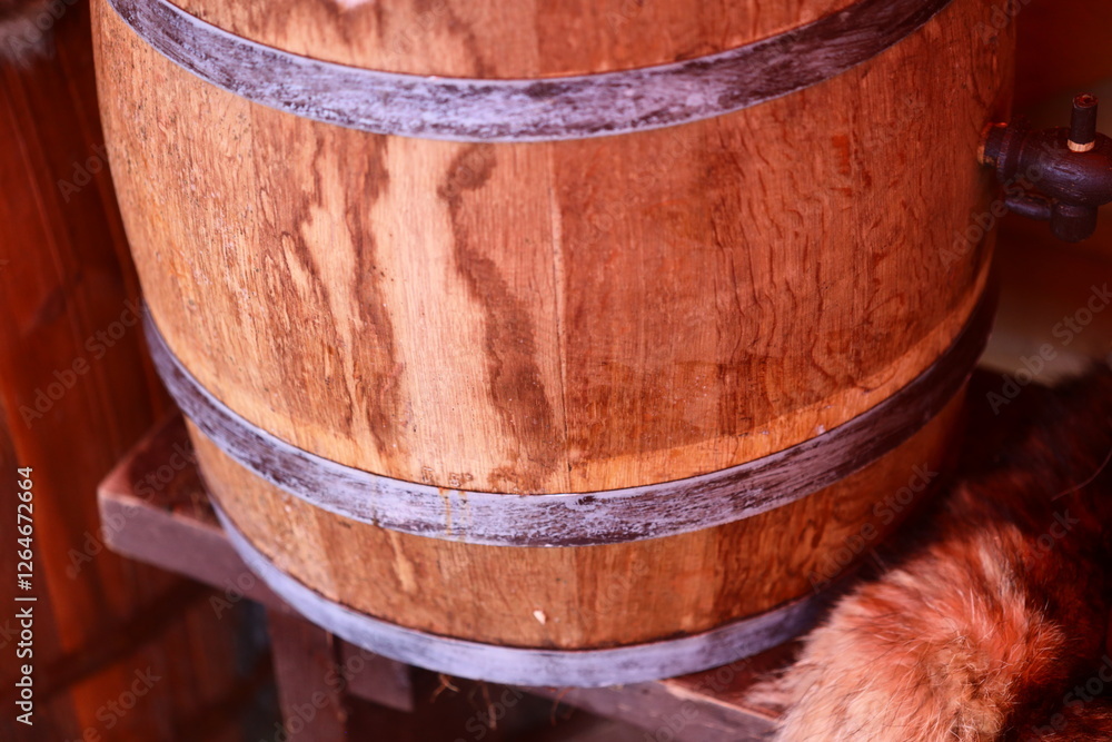 A domestic cat sits next to a wooden barrel in a casual pose. A domestic cat sits next to a wooden barrel in a casual pose.