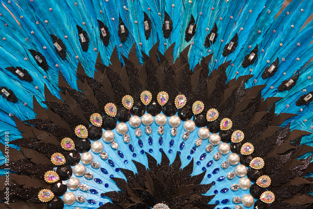 Handcrafted fan detail made with blue feathers and jewelry. Carnival