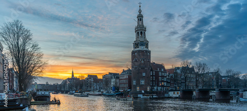 Amsterdam by Sunset, The Iconic Montelbaan Tower Amidst Canals and Picturesque Dutch houses photo