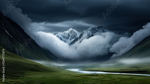 A dramatic mountain range with a winding river and lush green valley. photo