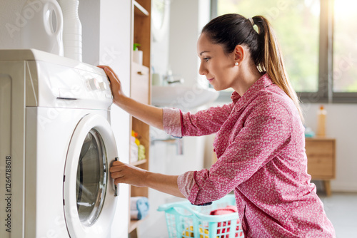 Fotografie Woman doing laundry at home