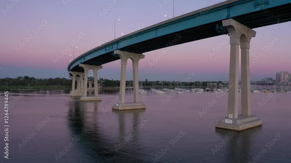 Drone flying underneath Coronado Bridge in San Diego towards boats.