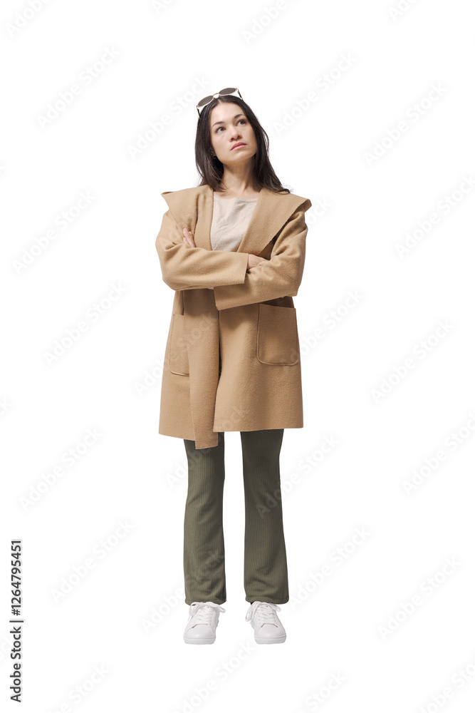 Young pensive woman standing and posing with arms crossed Young pensive woman standing and posing with arms crossed