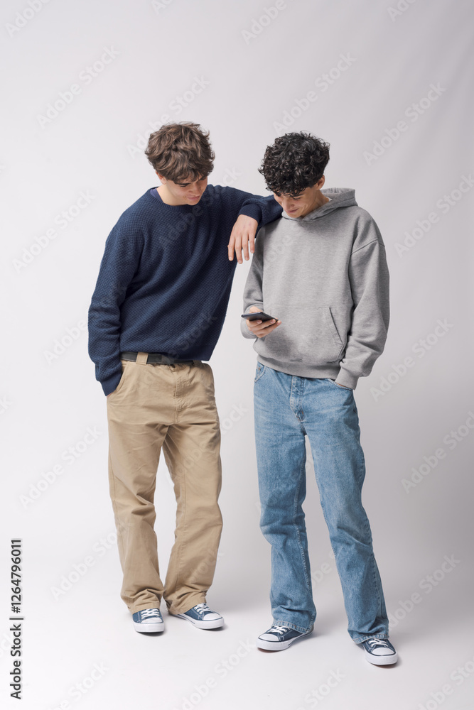 Friends checking social media on a smartphone together Friends checking social media on a smartphone together