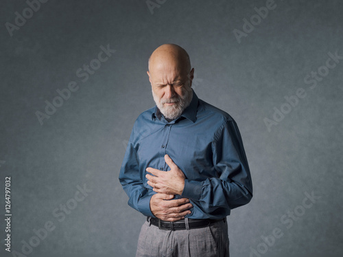 Senior man with stomach and belly pain photo