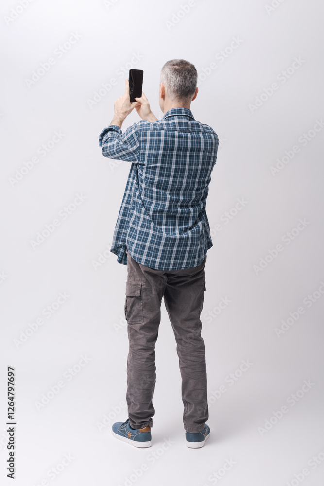 Man taking pictures with his smartphone Man taking pictures with his smartphone