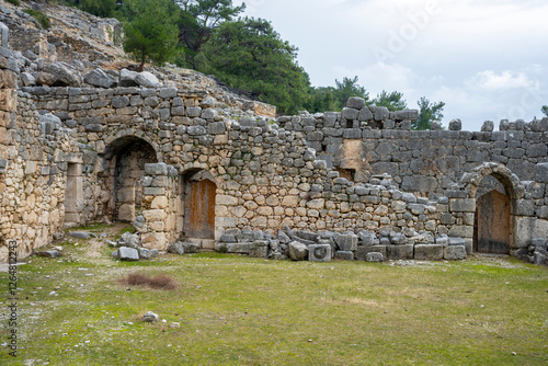 Remains of gymnasium in acnient Lycian city Arycanda. Ancient city on mountain near Aykiricay village.Well preserved semi-circular theater of Arycanda, ancient Lycian city in Antalya photo