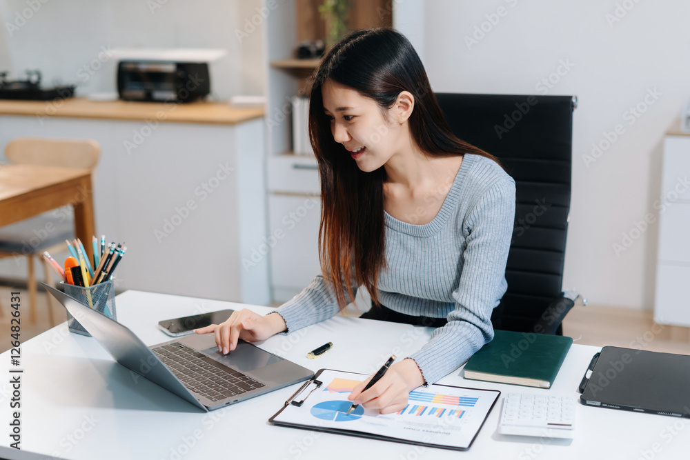 Women hand working with tablet and laptop computer with documents on office desk in modern office. Women hand working with tablet and laptop computer with documents on office desk in modern office.