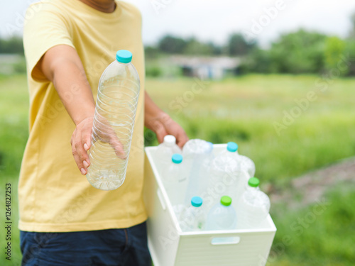 Wallpaper Mural Young man holding Plastic box with plastic bottles. Reuse, Reduce, Recycle concept. Torontodigital.ca